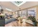 Inviting living room with skylight, hardwood floors, large windows, and stylish decor at 2684 S Adams St, Denver, CO 80210