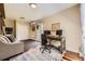 Comfortable office space with a wooden desk, two monitors, and a cozy seating area at 2684 S Adams St, Denver, CO 80210
