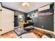 Contemporary office with dark gray walls, wood floors, a modern desk, and natural light at 2684 S Adams St, Denver, CO 80210