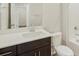 Modern bathroom with a stylish dark vanity, white countertop, and chrome fixtures at 6504 N Malaya St, Aurora, CO 80019