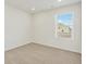 Bright and airy bedroom featuring carpet floors and a large window with a view at 6504 N Malaya St, Aurora, CO 80019