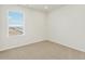 Bright bedroom with neutral carpet, large window, and ample natural light at 6504 N Malaya St, Aurora, CO 80019