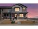 Charming two-story townhome featuring a covered porch and a mix of brick and siding for a modern aesthetic at 6504 N Malaya St, Aurora, CO 80019