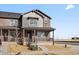 Attractive townhome featuring a covered porch, accented with a mix of brick and siding at 6504 N Malaya St, Aurora, CO 80019