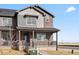 Inviting two-story townhome with a covered porch, showcasing a blend of brick and siding finishes at 6504 N Malaya St, Aurora, CO 80019