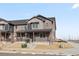 Well-designed townhome with a covered porch and a blend of brick and siding, perfect for modern living at 6504 N Malaya St, Aurora, CO 80019