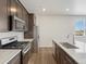 Modern kitchen with stainless steel appliances, wood cabinets and stone countertops at 6504 N Malaya St, Aurora, CO 80019