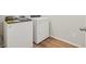 Convenient laundry room with modern appliances and durable wood-look floors at 6504 N Malaya St, Aurora, CO 80019