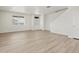 Spacious living room with wood-look flooring, a large window, and a contemporary open floorplan design at 6504 N Malaya St, Aurora, CO 80019