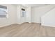 Bright living room boasts wood-look flooring and a large window that allows natural light to illuminate the space at 6504 N Malaya St, Aurora, CO 80019