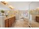 Luxurious bathroom with double vanities, granite countertops, tile floors, and a separate tub and shower at 7717 S Grape Ct, Centennial, CO 80122