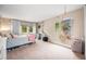 Cozy bedroom with a hanging chair, natural light, and a comfortable bed, creating a relaxing space at 7717 S Grape Ct, Centennial, CO 80122