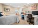 Comfortable bedroom with a desk and chair, personalized decor, and a cozy sleeping space at 7717 S Grape Ct, Centennial, CO 80122