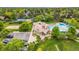 Aerial view of community featuring swimming pool, tennis courts, and clubhouse nestled in lush greenery at 7717 S Grape Ct, Centennial, CO 80122