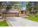 Beautiful two-story home with a well-maintained lawn and a spacious driveway at 7717 S Grape Ct, Centennial, CO 80122