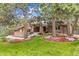 Charming two-story home with a brick facade, mature trees, and a green lawn at 7717 S Grape Ct, Centennial, CO 80122