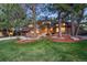 Charming two-story brick home with well-manicured lawn and mature trees at 7717 S Grape Ct, Centennial, CO 80122