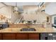 Kitchen island features granite countertops, stainless sink, and view into living area at 7717 S Grape Ct, Centennial, CO 80122