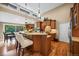 Large kitchen island with seating, pendant lights, and stainless steel appliances at 7717 S Grape Ct, Centennial, CO 80122