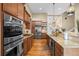 Gourmet kitchen with stainless steel appliances, wood cabinets and granite counters at 7717 S Grape Ct, Centennial, CO 80122