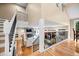 Open concept main living area with hardwood floors and a view of the fireplace at 7717 S Grape Ct, Centennial, CO 80122