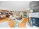 Spacious living room with hardwood floors, stone fireplace, and staircase access to the upper level at 7717 S Grape Ct, Centennial, CO 80122