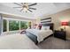 Serene main bedroom with vaulted ceilings, large windows, and a spacious layout, offering lots of natural light at 7717 S Grape Ct, Centennial, CO 80122