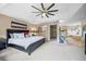 Spacious main bedroom featuring a large bed, ceiling fan, and ensuite bathroom with a soaking tub at 7717 S Grape Ct, Centennial, CO 80122