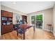 Well-lit office featuring hardwood floors, built-in shelving, and a sliding door to the outdoor patio at 7717 S Grape Ct, Centennial, CO 80122
