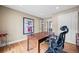 Bright office area with hardwood floors, a classic desk, and access to other rooms in the house at 7717 S Grape Ct, Centennial, CO 80122