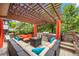 Inviting outdoor lounge featuring a built-in grill, fire pit, and comfortable seating under a wooden pergola at 7717 S Grape Ct, Centennial, CO 80122