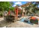 Outdoor bar and lounge area with a built-in grill, comfortable seating, and shade from a wooden pergola at 7717 S Grape Ct, Centennial, CO 80122