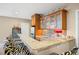 Basement wet bar area with granite countertop, wooden cabinets, and modern beverage cooler at 7717 S Grape Ct, Centennial, CO 80122