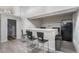 Clean, simple bar space with stools, countertop, fridge and a black backsplash at 10150 E Virginia Ave # 13-204, Denver, CO 80247