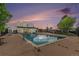 Community swimming pool with surrounding lounge area and dusk skies at 10150 E Virginia Ave # 13-204, Denver, CO 80247