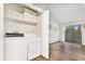 Laundry closet and hardwood floors leading to sliding glass door and lots of light at 10150 E Virginia Ave # 13-204, Denver, CO 80247