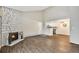 Open living space with fireplace, hardwood floors, and ample light at 10150 E Virginia Ave # 13-204, Denver, CO 80247