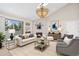 Inviting living room features a fireplace, chandelier, comfortable seating, and natural light at 10150 E Virginia Ave # 13-204, Denver, CO 80247