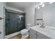 Updated bathroom features glass enclosed tiled shower, modern vanity, and wood look flooring at 1028 Coronado Pkwy # C, Denver, CO 80229