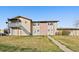 Inviting townhome featuring a well-maintained lawn, neutral color scheme, and a stairway entry to the second level at 1028 Coronado Pkwy # C, Denver, CO 80229