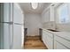 Clean kitchen with white cabinets, stainless steel appliances, sleek countertops, and a window for natural light at 1028 Coronado Pkwy # C, Denver, CO 80229