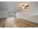 Bright living room featuring light wood floors, neutral walls, sliding glass doors and a ceiling fan at 1028 Coronado Pkwy # C, Denver, CO 80229