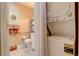 Efficient bathroom with a toilet, stacked washer and dryer, and accessible features at 4931 Garrison St # 204G, Wheat Ridge, CO 80033