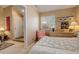 Light-filled bedroom features neutral walls, comfortable bed, dresser, and a cozy sitting area at 4931 Garrison St # 204G, Wheat Ridge, CO 80033
