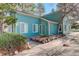 Charming turquoise home featuring well-kept siding and a landscaped garden bed, adding curb appeal at 4931 Garrison St # 204G, Wheat Ridge, CO 80033