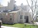 Tan townhouse featuring a brick facade, green lawn, and well-lit exterior at 4931 Garrison St # 204G, Wheat Ridge, CO 80033