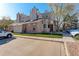 Exterior view of condo featuring brick and tan siding, chimney, designated parking, and well-maintained landscaping at 4931 Garrison St # 204G, Wheat Ridge, CO 80033