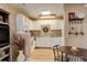 Functional kitchen with a dining area, bright cabinets, and ample counter space and natural light at 4931 Garrison St # 204G, Wheat Ridge, CO 80033