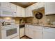 Well-maintained kitchen featuring bright cabinets, efficient appliances, and durable countertops at 4931 Garrison St # 204G, Wheat Ridge, CO 80033