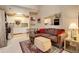 Living room with an open layout, neutral decor, light carpet, and a view of the adjoining kitchen at 4931 Garrison St # 204G, Wheat Ridge, CO 80033